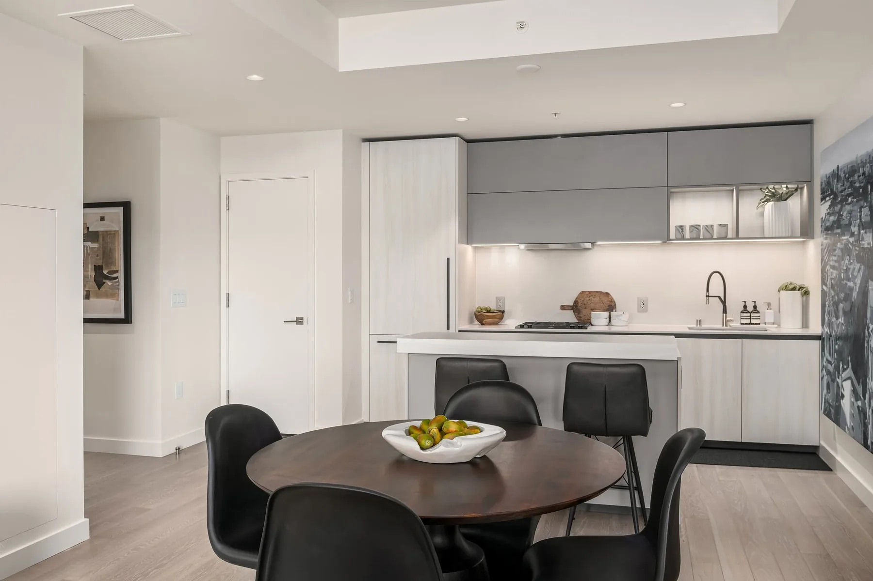 Seattle home staging featuring a contemporary kitchen island and round dining table set for a polished market-ready presentation