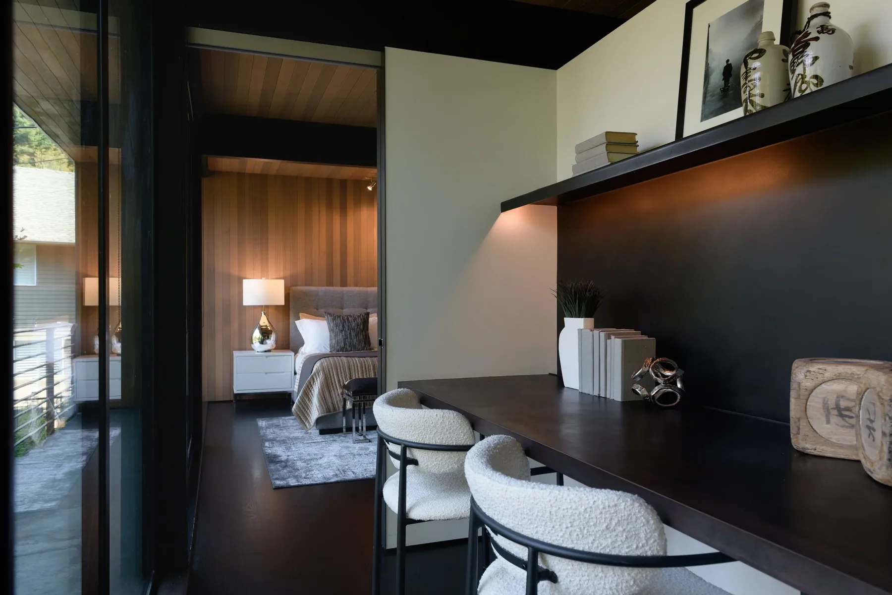 Seattle luxury home staging with a styled hallway leading to a serene bedroom and a built-in desk nook