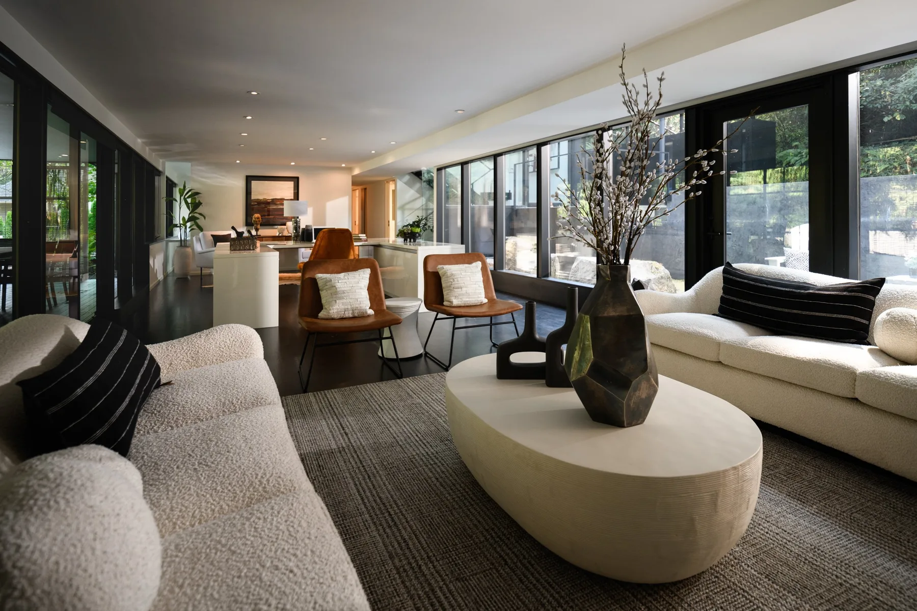 Seattle luxury home staging featuring an open great room with a sculptural stone coffee table and bouclé seating
