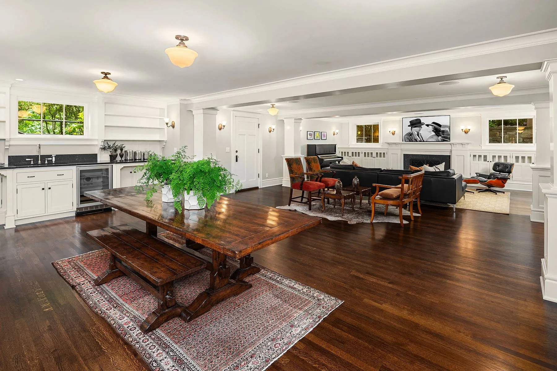 Seattle home staging with an open great room, antique runner, dark hardwood floors, and a long farmhouse dining table