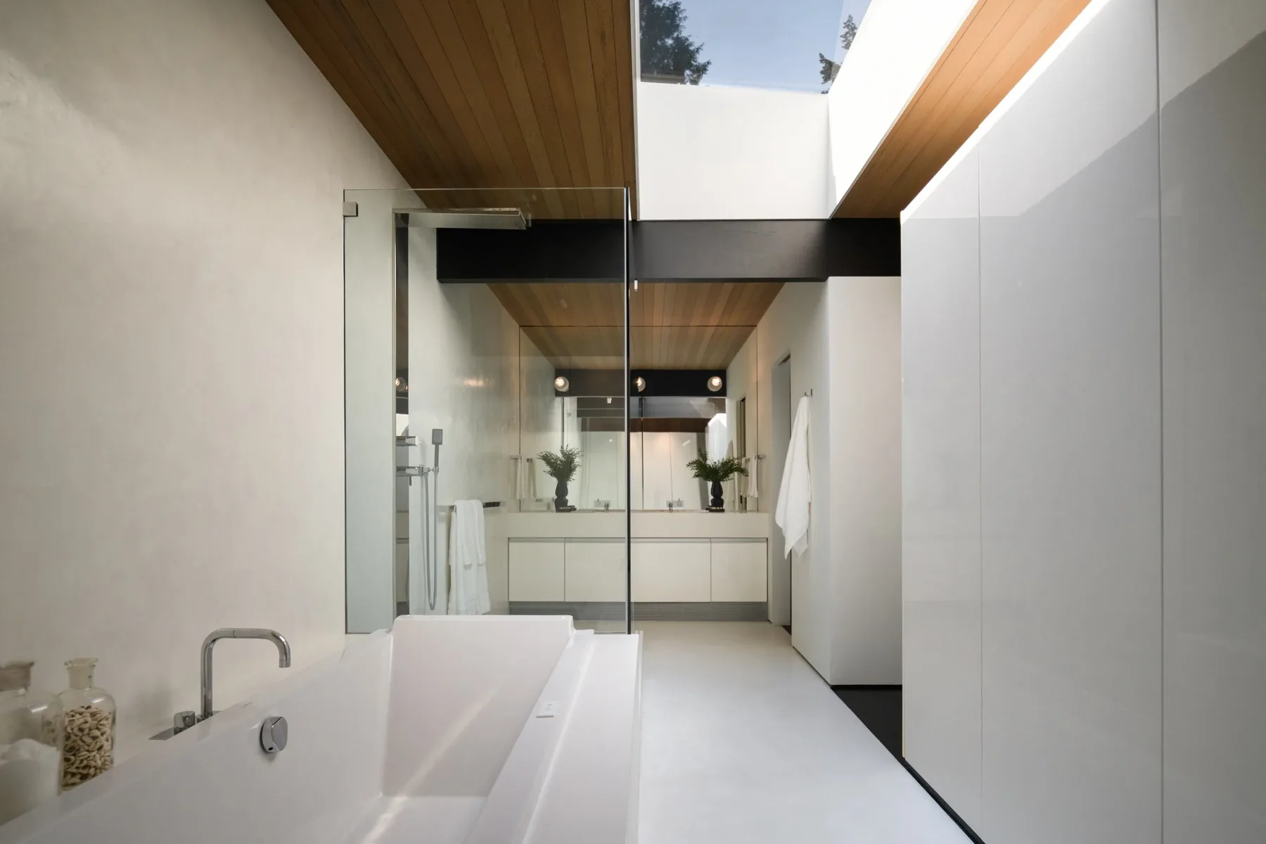 Seattle luxury home staging featuring a spa-like primary bathroom with a freestanding soaking tub and warm wood ceiling