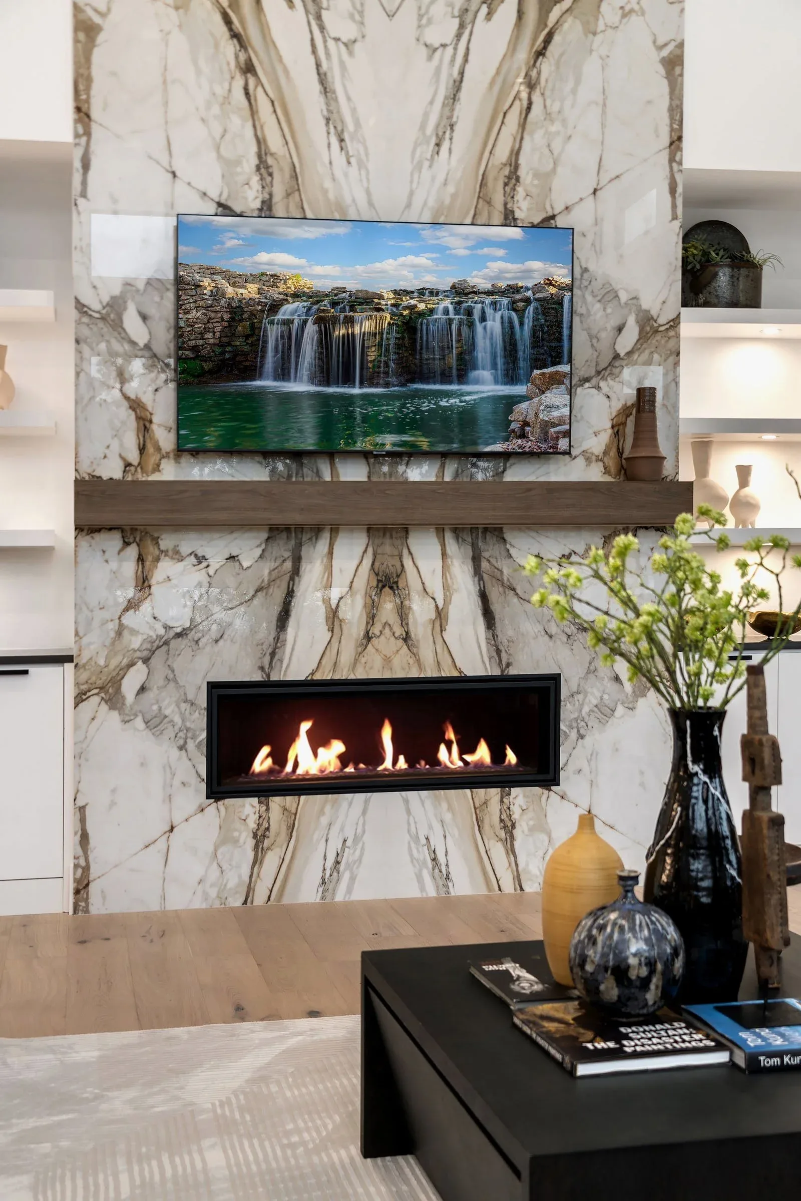 Seattle luxury home staging featuring a fireside living area with a dramatic book-matched marble fireplace and warm wood mantel