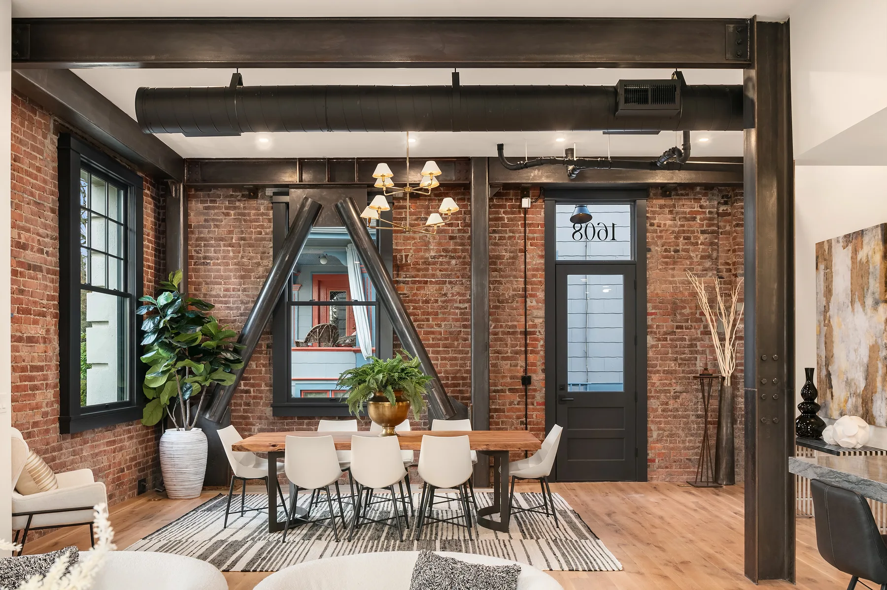 Dining area with a live-edge wood table set beneath industrial steel cross-bracing