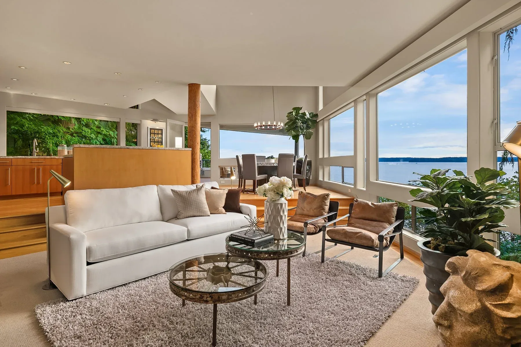 Seattle luxury home staging featuring a Puget Sound bluffside modern home with vaulted cedar ceilings, walls of glass, and warm contemporary furnishings overlooking the water