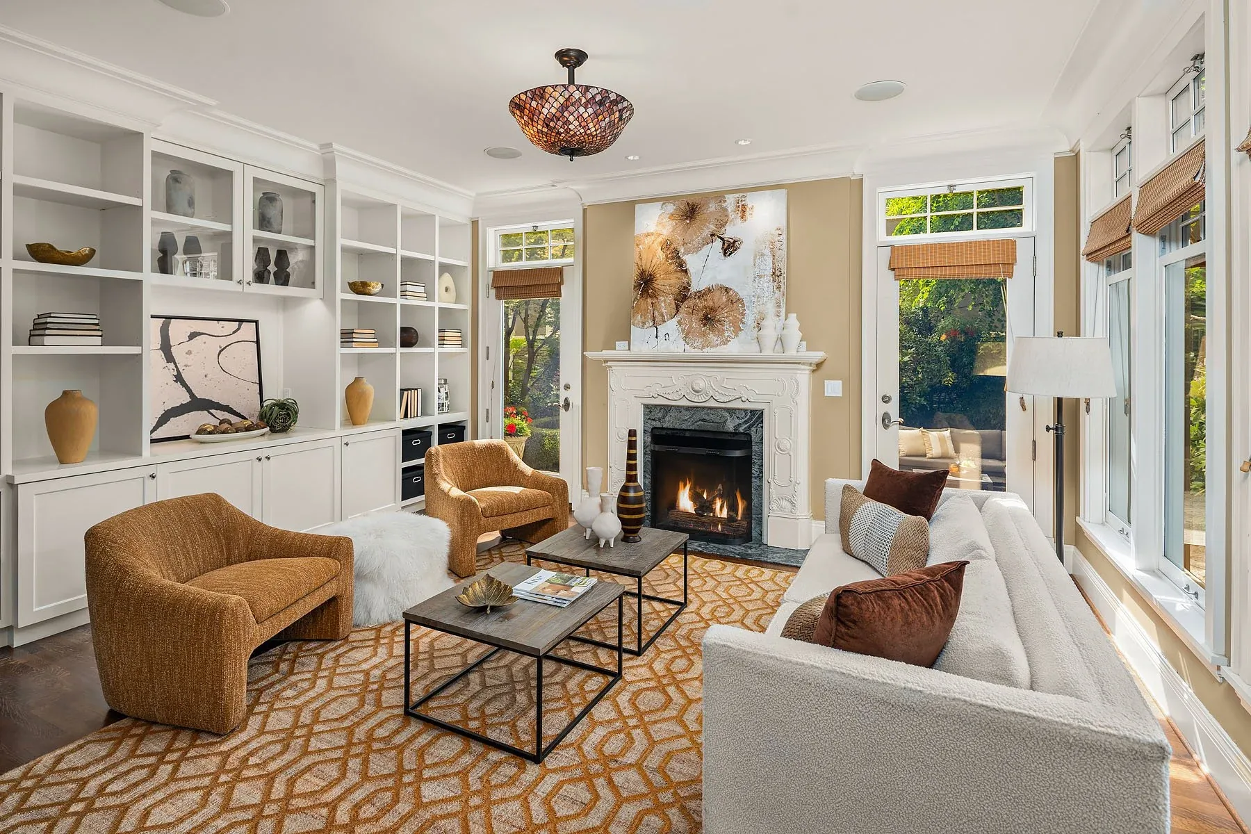 Capitol Hill home staging featuring a family room with built-in shelving, a fireplace, and curved bouclé and leather seating
