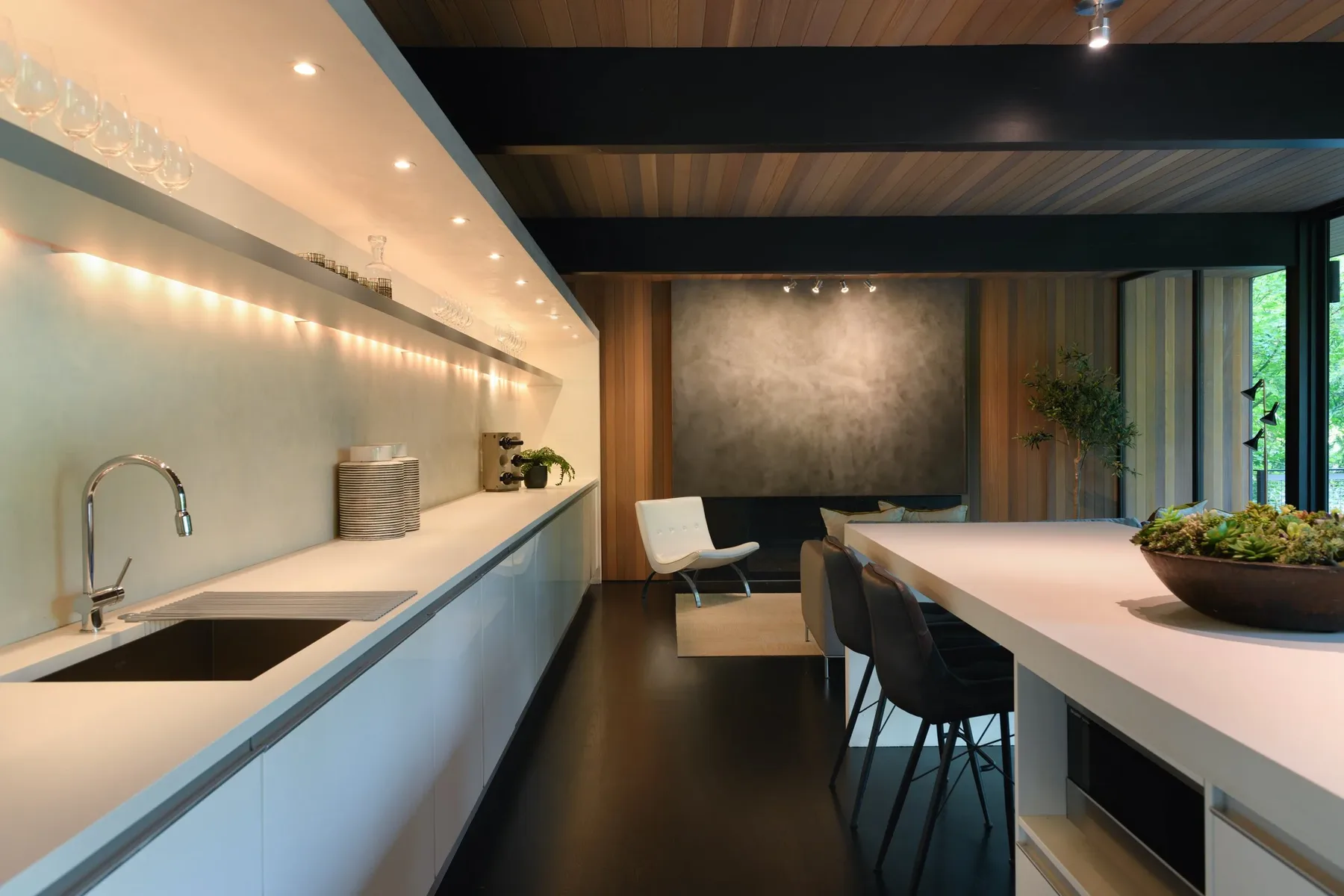 Seattle home staging with an open kitchen and adjacent lounge seating beneath a warm wood ceiling