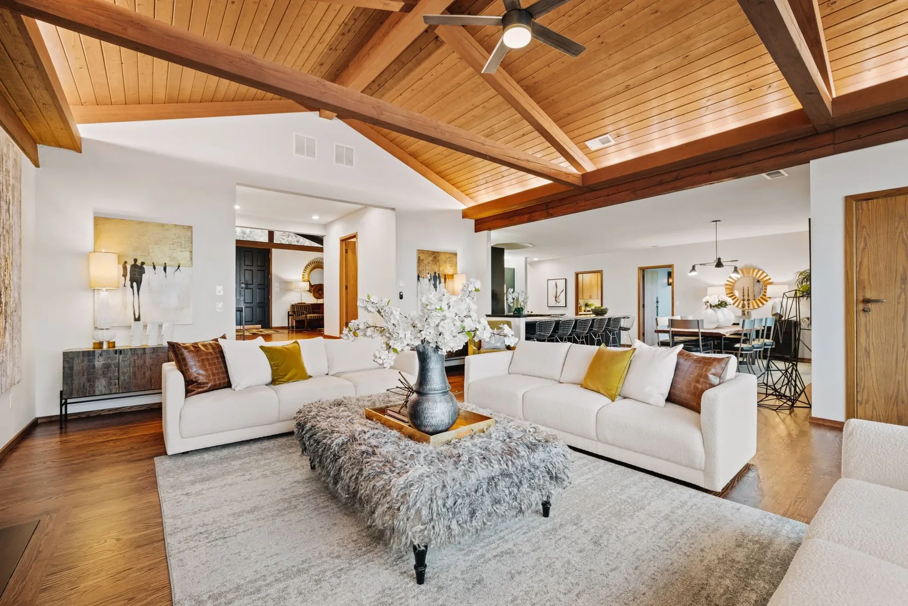 Seattle luxury home staging with an open living and kitchen space under a vaulted cedar ceiling and warm wood paneling